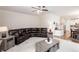 Open living room with a leather sectional and seamless transition to the kitchen at 637 Little Bear Loop, Canton, GA 30114