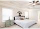 Bright main bedroom with tray ceiling, ceiling fan, and neutral-toned walls and carpet at 637 Little Bear Loop, Canton, GA 30114