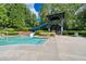 Community pool featuring a slide and wading area, surrounded by lush landscaping for outdoor fun at 637 Little Bear Loop, Canton, GA 30114
