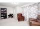 Comfortable sitting area with a reading chair, desk, bookshelf, and window at 637 Little Bear Loop, Canton, GA 30114
