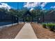 Tennis court entrance featuring shaded picnic area and walkway, providing a welcoming and functional space for community residents at 637 Little Bear Loop, Canton, GA 30114