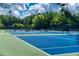 Blue tennis courts with green surroundings, perfect for sports enthusiasts seeking recreational opportunities at 637 Little Bear Loop, Canton, GA 30114