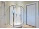 Bathroom featuring tiled corner shower with glass enclosure, complemented by a neutral color palette at 655 Moreland Se Ave, Atlanta, GA 30316