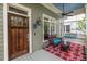 Inviting front porch with wooden door, chair and a swing, perfect for relaxing outdoors at 655 Moreland Se Ave, Atlanta, GA 30316