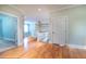 Open hallway area with hardwood floors, white trim, and access to other rooms at 655 Moreland Se Ave, Atlanta, GA 30316