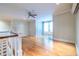 Upstairs loft area with hardwood floors, ceiling fan, and natural light from the window at 655 Moreland Se Ave, Atlanta, GA 30316