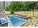Sparkling pool with a stone path, waterfall feature, and lush greenery at 655 Moreland Se Ave, Atlanta, GA 30316