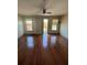 Bright living room featuring hardwood floors, ceiling fan, and sliding doors at 898 Oak St # 3412, Atlanta, GA 30310