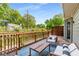 Relaxing back deck with comfortable outdoor seating, wooden railings, and scenic view of the lush greenery at 1420 Defoors Nw Dr, Atlanta, GA 30318