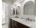 Bathroom features a double sink vanity, updated fixtures, and arched mirrors at 1420 Defoors Nw Dr, Atlanta, GA 30318