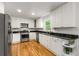 Kitchen featuring stainless appliances, white cabinets, hardwood floors and granite countertops at 1420 Defoors Nw Dr, Atlanta, GA 30318