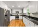 Kitchen featuring stainless appliances, white cabinets, hardwood floors and granite countertops at 1420 Defoors Nw Dr, Atlanta, GA 30318
