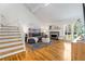 Bright living room features vaulted ceiling, hardwood floors, fireplace, and staircase at 1420 Defoors Nw Dr, Atlanta, GA 30318