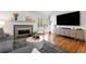 Bright living room features hardwood floors, fireplace, large television, and natural light at 1420 Defoors Nw Dr, Atlanta, GA 30318