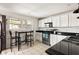Modern kitchen with white cabinets, stainless steel appliances, and breakfast bar at 24 Daniel Se St # 3, Atlanta, GA 30312