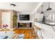 Open-concept living area with hardwood floors, exposed brick, and a view of the kitchen at 24 Daniel Se St # 3, Atlanta, GA 30312