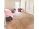 Bright bedroom with chairs, a plush rug, and a comfortable bed, creating a cozy retreat at 573 Emporia Loop, Mcdonough, GA 30253