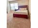 Comfortable bedroom features a large window and a plush bed with decorative pillows and a dark wood frame at 573 Emporia Loop, Mcdonough, GA 30253
