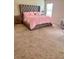 Elegant bedroom showcasing a plush bed, side tables, and soft carpeting for added comfort at 573 Emporia Loop, Mcdonough, GA 30253