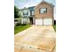 Charming two-story home with a brick facade and a well-maintained front yard at 573 Emporia Loop, Mcdonough, GA 30253