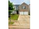 Charming two-story home with a brick facade and a well-maintained front yard at 573 Emporia Loop, Mcdonough, GA 30253