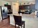 Updated kitchen with granite countertops, stainless steel appliances, and wood cabinets at 573 Emporia Loop, Mcdonough, GA 30253