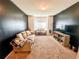 Cozy living room with a large window, neutral decor, and comfortable seating at 573 Emporia Loop, Mcdonough, GA 30253