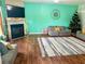 Cozy living room featuring a fireplace, hardwood floors, and a Christmas tree at 573 Emporia Loop, Mcdonough, GA 30253