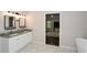 Bathroom boasts a double vanity with granite counters, framed mirrors, and tile floors at 7307 Banks Mill Rd, Douglasville, GA 30135