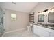 Modern bathroom featuring double vanity, granite counters, industrial shelving, and stylish fixtures at 7307 Banks Mill Rd, Douglasville, GA 30135