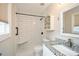 Stylish bathroom features a walk-in shower with white subway tile and a granite vanity at 7307 Banks Mill Rd, Douglasville, GA 30135