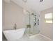 Bright bathroom with modern fixtures, including a soaking tub and separate glass enclosed shower at 7307 Banks Mill Rd, Douglasville, GA 30135