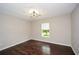 Bedroom with hardwood floors and a window overlooking the yard at 7307 Banks Mill Rd, Douglasville, GA 30135