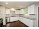 Bright, remodeled kitchen with white cabinets, granite counters, and stainless steel appliances at 7307 Banks Mill Rd, Douglasville, GA 30135