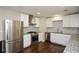 Modern kitchen featuring stainless steel appliances, granite countertops, and stylish backsplash at 7307 Banks Mill Rd, Douglasville, GA 30135