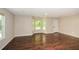 Bright living area boasts hardwood floors, a large window, and a neutral color scheme at 7307 Banks Mill Rd, Douglasville, GA 30135