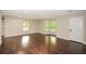 Spacious living room featuring hardwood floors, natural light, and neutral wall colors at 7307 Banks Mill Rd, Douglasville, GA 30135