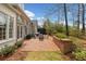 Inviting brick patio with manicured garden and mature trees that provide extra privacy at 1128 Bellewood Sq, Dunwoody, GA 30338