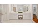 Elegant bathroom featuring double vanities, a makeup counter and large mirrors framed by stylish lighting at 1128 Bellewood Sq, Dunwoody, GA 30338