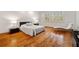 Minimalist bedroom with hardwood floors, shuttered windows, and bedside tables with contemporary lamps at 1128 Bellewood Sq, Dunwoody, GA 30338
