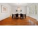 Elegant dining room with hardwood floors, shuttered windows, and a modern light fixture at 1128 Bellewood Sq, Dunwoody, GA 30338