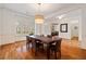 Formal dining room featuring hardwood floors, elegant light fixtures, and window shutters at 1128 Bellewood Sq, Dunwoody, GA 30338