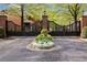 Elegant gated entrance with brick pillars and beautiful landscaping, enhancing curb appeal at 1128 Bellewood Sq, Dunwoody, GA 30338