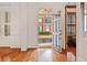 Bright foyer showcasing hardwood floors and a view of the exterior through the open front door at 1128 Bellewood Sq, Dunwoody, GA 30338
