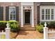 Close up of the home's front door showing brick walkway and meticulous landscaping at 1128 Bellewood Sq, Dunwoody, GA 30338