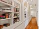 Hallway featuring built-in bookshelves and arched windows, adding character and storage at 1128 Bellewood Sq, Dunwoody, GA 30338