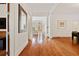 Spacious hallway featuring gleaming hardwood floors, white walls, and detailed molding at 1128 Bellewood Sq, Dunwoody, GA 30338