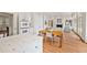 Spacious kitchen with an island, white cabinets and stainless appliances offering plenty of workspace at 1128 Bellewood Sq, Dunwoody, GA 30338