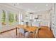 Bright kitchen featuring white cabinets, center island, stainless steel appliances, and hardwood floors at 1128 Bellewood Sq, Dunwoody, GA 30338