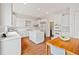 Well-lit kitchen with stainless appliances, a center island, ample storage, and hardwood floors at 1128 Bellewood Sq, Dunwoody, GA 30338